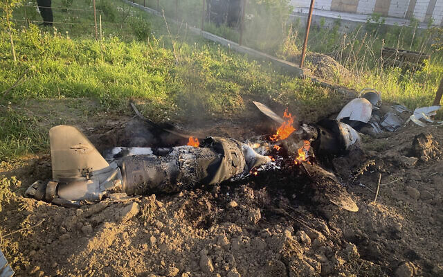 In this photo provided by the Ukrainian Police Press Office, fragments of a Russian rocket which was shot down by Ukraine's air defence system are seen after the night rocket attack in the Kyiv region, Ukraine, May 18, 2023. (Ukrainian Police Press Office via AP)