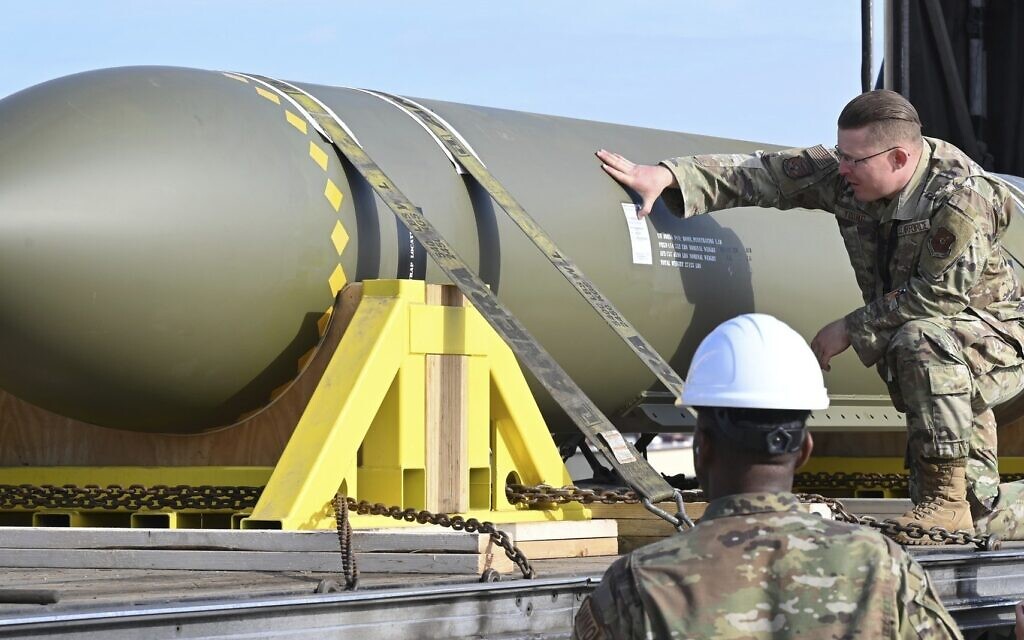 In this photo released by the US Air Force on May 2, 2023, airmen look at a GBU-57, or the Massive Ordnance Penetrator bomb, at Whiteman Air Base in Missouri (US Air Force via AP)