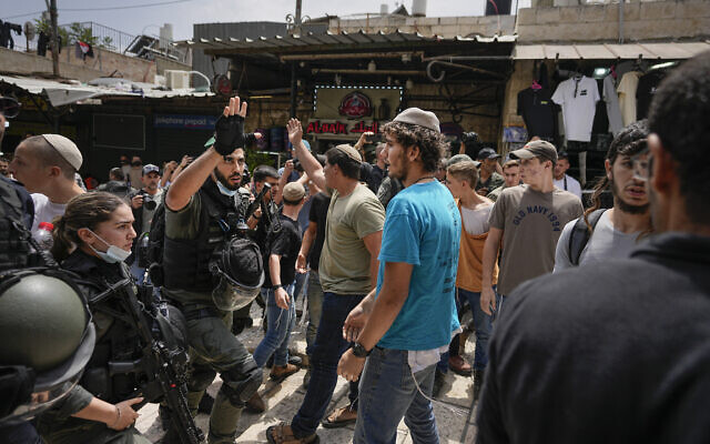 Police officers separate Israelis and Palestinians during a march marking Jerusalem Day, in front of the Damascus Gate of Jerusalem's Old City, May 18, 2023. (AP Photo/Ohad Zwigenberg)