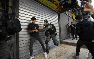 Israeli police push away Palestinians from a street in the Muslim Quarter of Jerusalem's Old City, shortly before a march through the area by Jewish nationalists, Thursday, May 18, 2023. (AP /Ohad Zwigenberg)