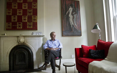 File: British novelist Martin Amis poses in the living room of his new home in the Brooklyn borough of New York on Aug. 17, 2012. (AP/Bebeto Matthews)