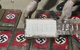 In this photo provided by the Peruvian Anti-Drug Police, an officer shows blocks of cocaine marked with Nazi swastikas and stamped with the name "HITLER", at the port of Paita, Piura region, Peru, Thursday, May 25, 2023.  (Peruvian Anti-Drug Police via AP)