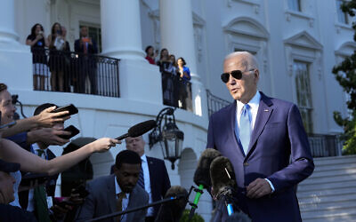 US President Joe Biden talks with reporters on the South Lawn of the White House in Washington, May 26, 2023, as he heads to Camp David for the weekend. (AP Photo/Susan Walsh)