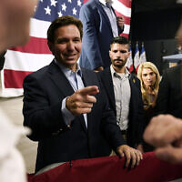 Republican presidential hopeful Florida Gov. Ron DeSantis greets audience members during a campaign event, May 30, 2023, in Clive, Iowa. (AP Photo/Charlie Neibergall)