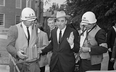 Edwin A. Walker under the custody of marshals on campus of Ole Miss in Oxford, Mississippi, October 1, 1962. (AP Photo)