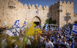 Thousands of Jews wave Israeli flags as they celebrate Jerusalem Day by dancing at Damascus Gate in Jerusalem's Old City, during Jerusalem Day, May 29, 2022. (Nati Shohat/Flash90)