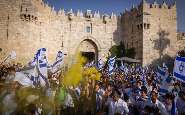 Thousands of Jews wave Israeli flags as they celebrate Jerusalem Day by dancing at Damascus Gate in Jerusalem's Old City, during Jerusalem Day, May 29, 2022. (Nati Shohat/Flash90)