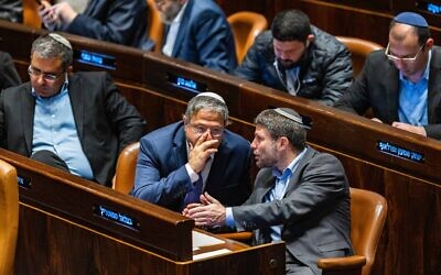 Finance Minister Bezalel Smotrich (right) of the Religious Zionism party talks to National Security Minister Itamar Ben Gvir of Otzma Yehudit in the Knesset plenum on December 28, 2022. (Olivier Fitoussi/ Flash90)