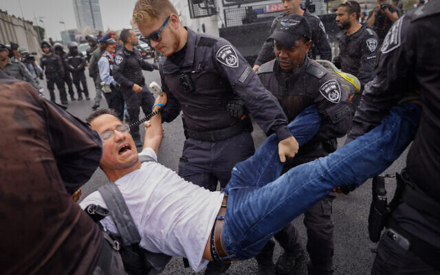 Protest leader Moshe Radman is arrested by police during a demonstration against the government's planned judicial overhaul on March 23, 2023. (Erik Marmor/Flash90)