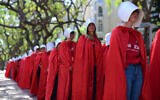 Israeli women dressed as characters from 'The Handmaid's Tale' television show protest against disadvantages for women in the state rabbinical courts and against the government's planned judicial overhaul, outside the Tel Aviv Rabbinical Court, May 4, 2023. (Tomer Neuberg/Flash90)