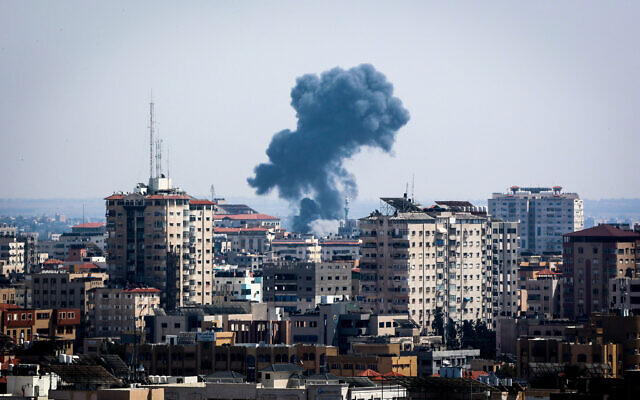 Smoke rises above buildings after IDF airstrikes the southern Gaza Strip, on May 11, 2023. (Atia Mohammed/Flash90)