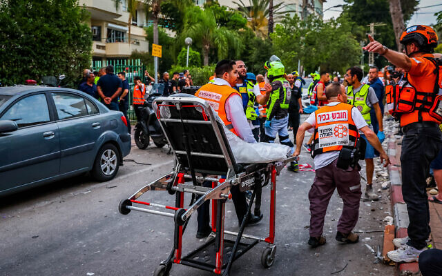 Police and rescue forces at the scene where a rocket fired from Gaza hit and damaged a house in Rehovot on May 11, 2023. Photo by  (Liron Moldovan/Flash90)