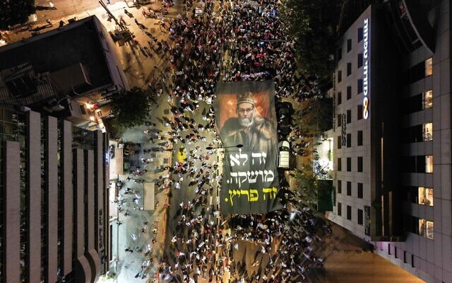 Protesters march in Bnei Brak against the billions in funds provided to ultra-Orthodox parties in the state budget, on May 17, 2023. (Omer Fichman/Flash90)