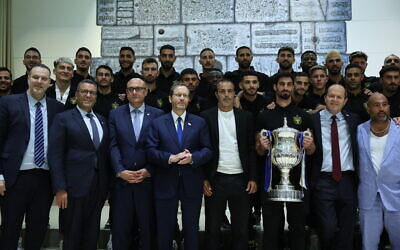 President Isaac Herzog at an event at which he presented Beitar Jerusalem soccer team with the State Cup, at his official residence in Jerusalem on May 24, 2023. (Yonatan SIndel/Flash90)