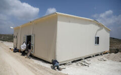 People work on a new yeshiva building in the outpost of Homesh, in the West Bank, on May 29, 2023. (Flash90)