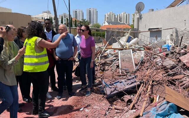 Avigdor Liberman and Yisrael Beytenu MKs visit the scene of a rocket attack in Ashkelon on May 11, 2023 (Carrie Keller-Lynn/The Times of Israel)