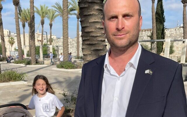 Otzma Yehudi MK Yitzhak Kroizer poses for a photo with his daughters at the Jerusalem Day Flag March just outside the Old City, May 18, 2023. (Jeremy Sharon/Times of Israel)