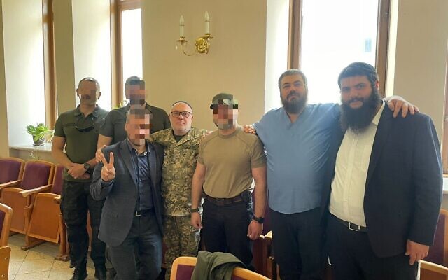 Rabbi David Milman (fourth from left) and mohel Dr. Yaakov Gaisinovich (second from right) join Ukrainian soldiers who underwent circumcisions in Kyiv, May 16, 2023 (Office of the Chief Rabbi)