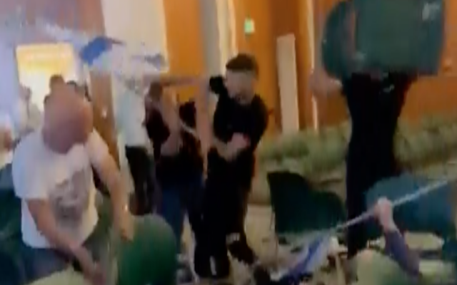 An employee assaults a protester at the Pastoral Kfar Blum Hotel in northern Israel, on May 15 2023. (Screengrab via Maariv used in accordance with Clause 27a of the Copyright Law)