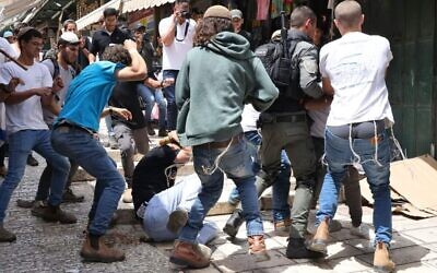 Israeli participants in the annual Flag March beat Palestinian residents of the Old City of Jerusalem on May 18, 2023. (Ir Amim)
