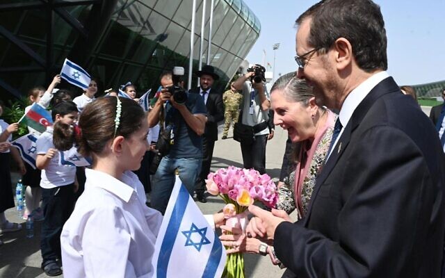 President Isaac Herzog and his wife Michal are greeted at the airport in Baku by Jewish schoolchildren from the Chabad Or Avner school, May 30, 2023 (Haim Zach/GPO). 
