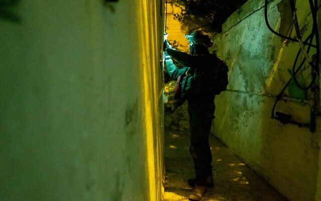 An Israeli soldier takes measurements at the home of a Palestinian terrorist in the West Bank city of Nablus, ahead of a potential demolition, early May 30, 2023. (Israel Defense Forces)