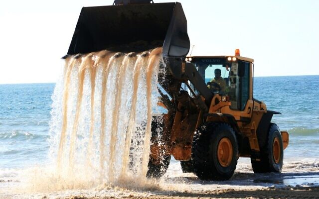 A bulldozer carries sand from the sea during construction of a hotel on the beachfront in Bat Yam on the central coast, March 14, 2011. (Nicky Kelvin/Flash 90)