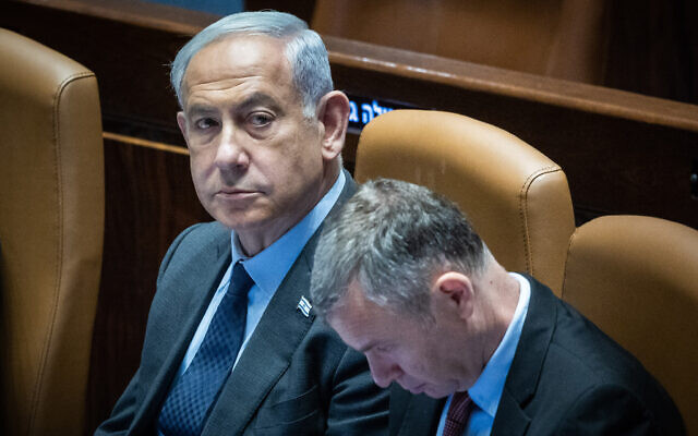 Prime Minister Benjamin Netanyahu, left, and Justice Minister Yariv Levin, right, during the opening of the summer session of the Knesset, in Jerusalem, May 1, 2023. (Yonatan Sindel/Flash90)