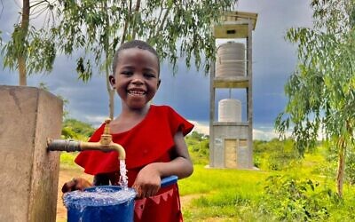 A child in Malawi enjoys clean water thanks to the work of Innovation Africa. (Innovation Africa)