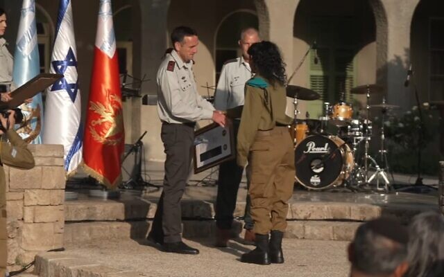 IDF chief Herzi Halevi hands a reservist soldier an award during a ceremony at the IDF headquarters in Tel Aviv, May 8, 2023. (Israel Defense Forces)