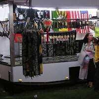 A swastika flag, left, is displayed for sale at a store at the Gladstone Harbour Festival in central Queensland, April 11, 2006. (Chris Donaghy/AAP Image via AP)