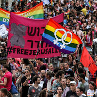 People march during the 21st annual Jerusalem Pride Parade on June 1, 2023. (AHMAD GHARABLI / AFP)