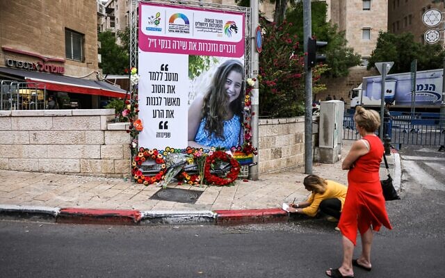 A memorial sign showing the image of Shira Banki, an Israeli teenager who was killed during the 2015 Jerusalem Pride Parade, is pictured during the 21st annual Jerusalem Pride Parade in Jerusalem on June 1, 2023. (AHMAD GHARABLI / AFP)