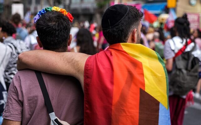Two people embrace as they march during the 21st annual Jerusalem Pride Parade in Jerusalem on June 1, 2023. (Menahem KAHANA / AFP)
