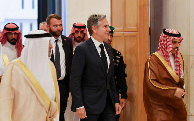 Saudi Foreign Minister Faisal bin Farhan (R) escorts US Secretary of State Antony Blinken (C) as they arrive for a meeting with GCC Ministers at the GCC Secretariat in Riyadh on June 7, 2023. (Photo by AHMED YOSRI / POOL / AFP)