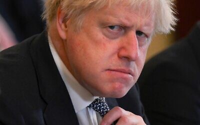 In this file photo taken on May 24, 2022 Britain's then prime minister Boris Johnson adjusts his tie at the start of a cabinet meeting at 10 Downing Street in London. Johnson announced his resignation as an MP on June 9, 2023, accusing a parliamentary probe into the 'Partygate' scandal of driving him out. (Daniel Leal/Pool/AFP)