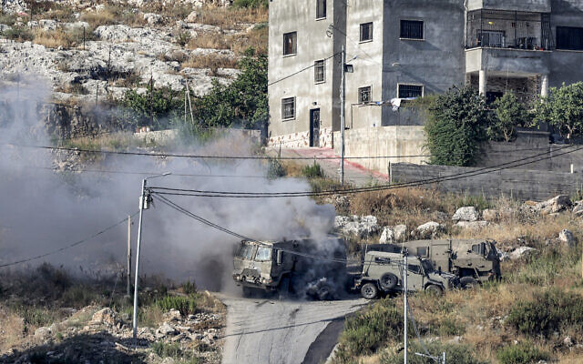 Smoke billows from the aftermath of the detonation of a Palestinian explosive charge on an Israeli armored vehicle during an Israeli army raid in Jenin in the West Bank on June 19, 2023. (Jaafar ASHTIYEH / AFP)
