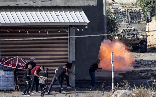 An explosive charge left by Palestinians detonates before an Israeli armoured vehicle during an Israeli army raid in Jenin in the West Bank on June 19, 2023. (Jaafar ASHTIYEH / AFP)