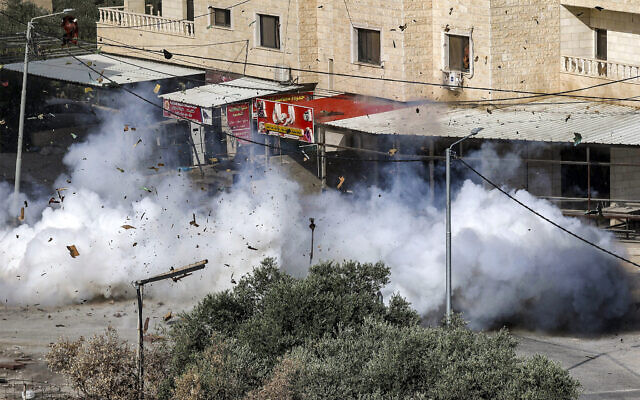 Smoke erupts from the detonation of an explosive charge left by Palestinians along a road during an Israeli army raid in Jenin in the West Bank on June 19, 2023. (Jaafar ASHTIYEH / AFP)