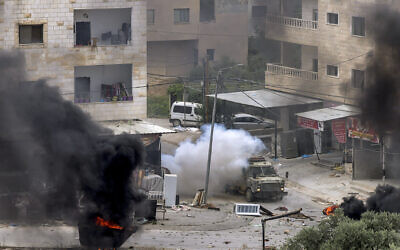 An explosive charge left by Palestinians detonates near an Israeli armored vehicle during an Israeli army raid in Jenin in the West Bank on June 19, 2023. (Jaafar ASHTIYEH / AFP)
