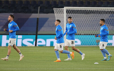 Mohammed Abu Fani (R) and other Israel players warm up ahead of the UEFA Euro 2024 group I qualifying round football match between Israel and Andorra at Teddy Stadium in Jerusalem, on June 19, 2023. (JACK GUEZ / AFP)
