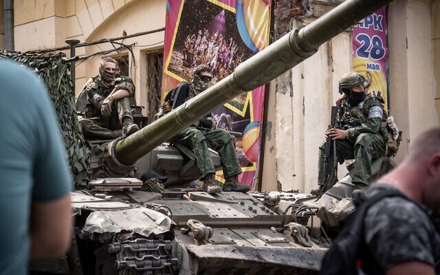 Members of Wagner Group sit atop of a tank in a street in the city of Rostov-on-Don, on June 24, 2023. (Roman Romokhov/AFP)