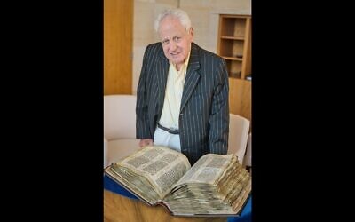 Alfred Moses stands in front of the Codex Sassoon, which he purchased for more than $30 million and will be donating it to the ANU Museum of the Jewish People in Tel Aviv. (Perry Bindelglass for The American Friends of ANU The Museum of the Jewish People via JTA)