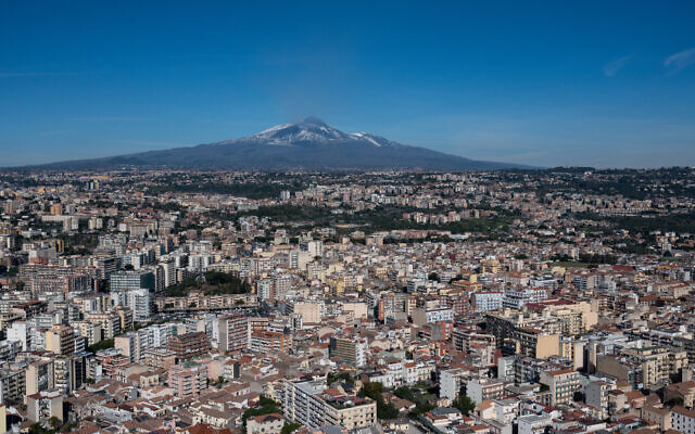 An aerial view of the city of Catania shows the Mt. Etna volcano in the background, January 28, 2022. (Fabrizio Villa/Getty Images via JTA)