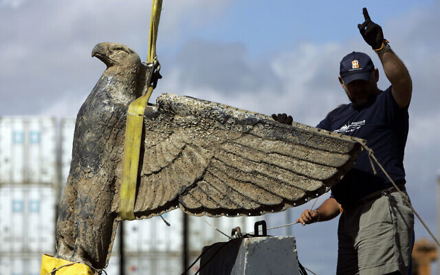 In this February 2006 file photo, an Uruguayan worker directs the salvage the eagle of World War II German pocket battleship Admiral Graf Spee, in Montevideo, Uruguay. (AP Photo/Marcelo Hernandez, File)