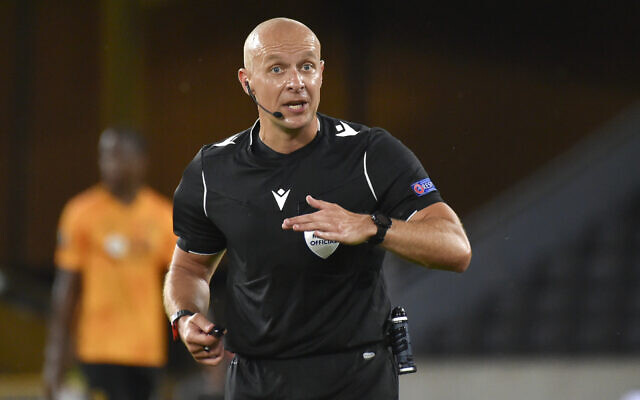 Referee Szymon Marciniak officiates at the Europa League round of 16 second leg soccer match between Wolves and Olympiakos at Molineux Stadium in Wolverhampton, England, August 6, 2020. (AP/Rui Vieira)