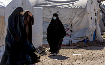 Women walk in Roj detention camp in northeast Syria, February 9, 2022. (Baderkhan Ahmad/AP)