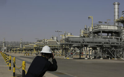 A photographer takes pictures of the Khurais oil field during a tour for journalists, 150 km east-northeast of Riyadh, Saudi Arabia, June 28, 2021. (AP/Amr Nabil)