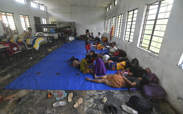 Refugees from Manipur rest in the northeastern Indian state of Assam, Sunday, May 7, 2023. (AP Photo/Panna Ghosh)