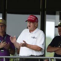 Former US President Donald Trump, Greg Norman, LIV Golf CEO, right, and Paul Myler, deputy head of mission for the Australian Embassy in Washington, left, watch the second round of the LIV Golf at Trump National Golf Club, Saturday, May 27, 2023, in Sterling, Va. (AP/Alex Brandon)